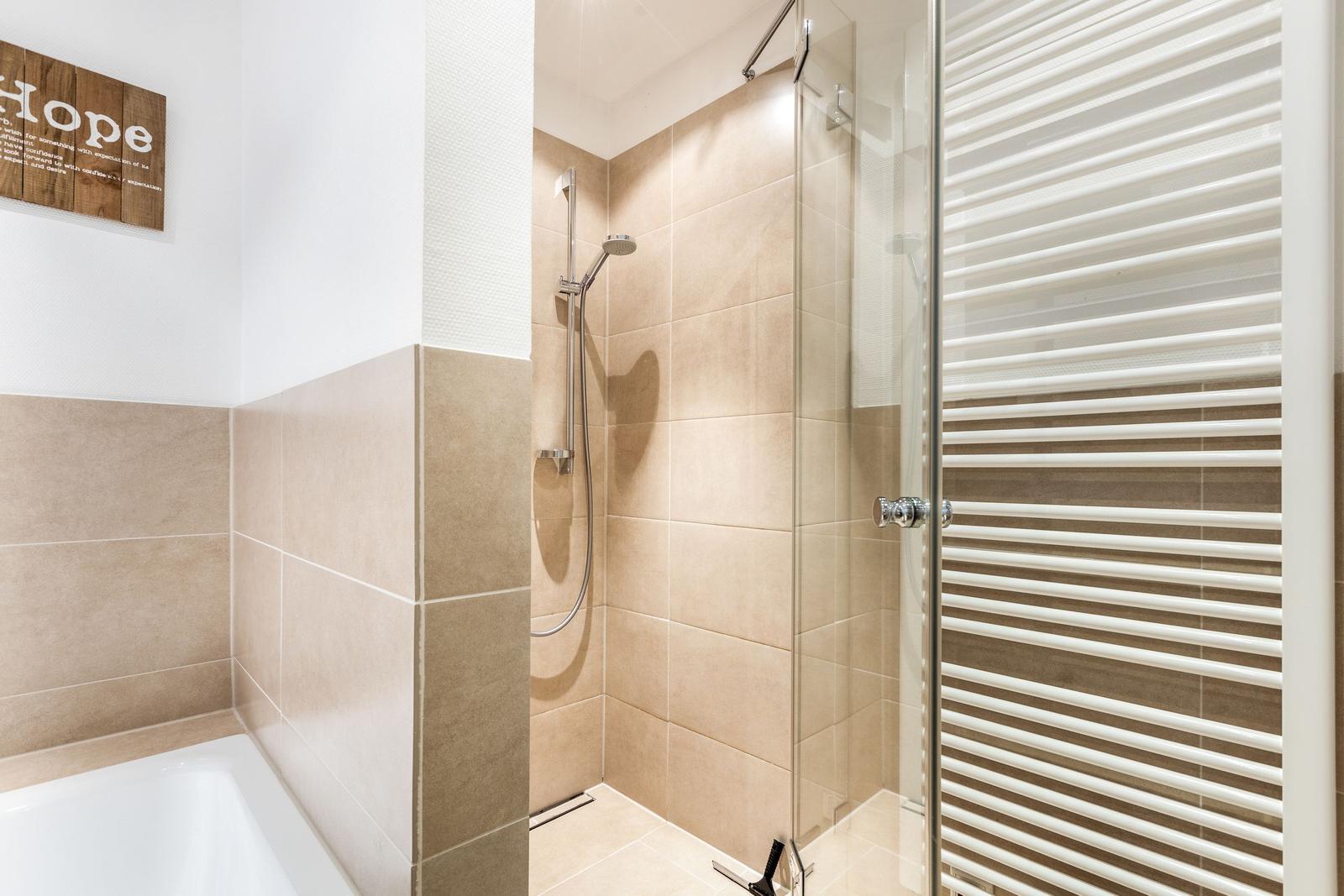 Bath with shower, bathtub, and heater