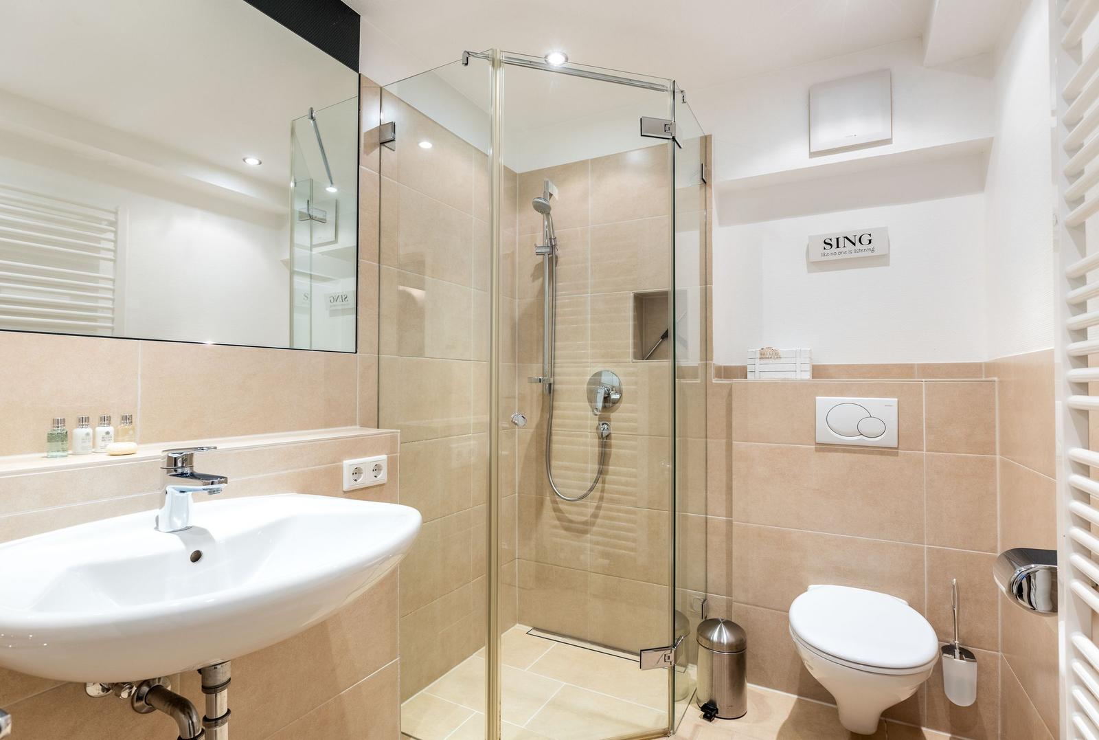 Bathroom with shower, sink, and toilet.