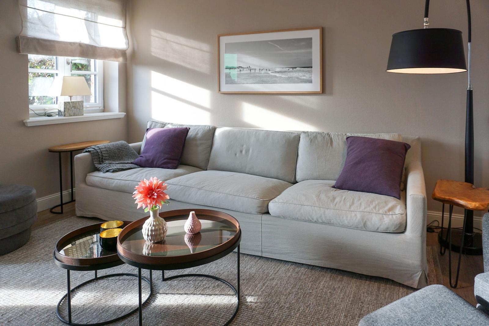 Living room with sofa, table, and wall art.