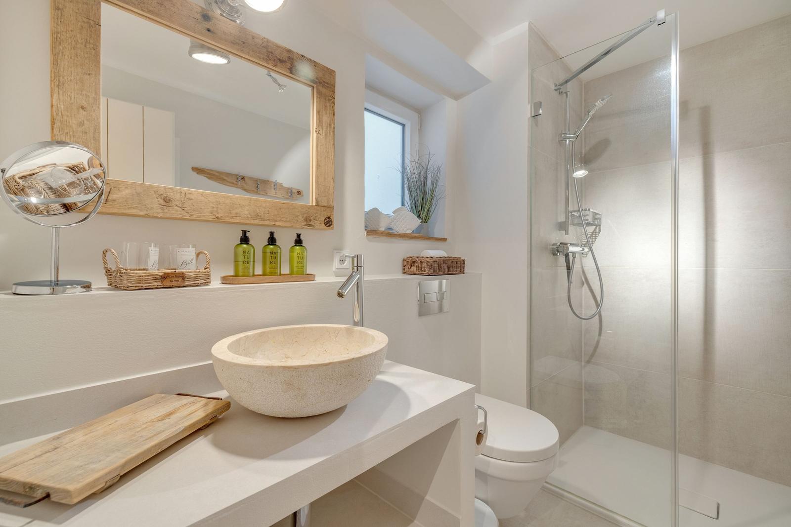Bathroom with shower, sink, and mirror