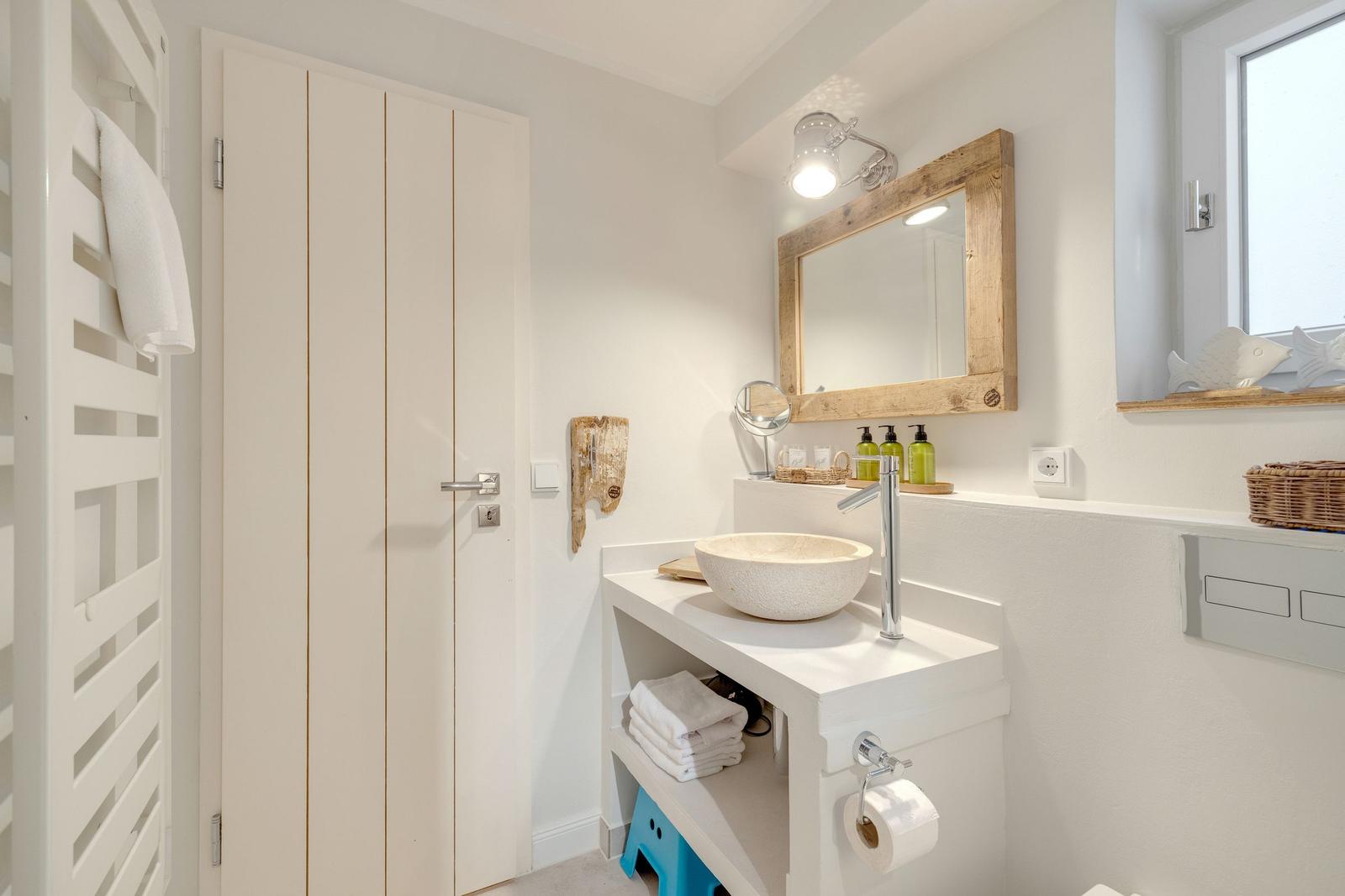 Bathroom with sink, mirror, and window