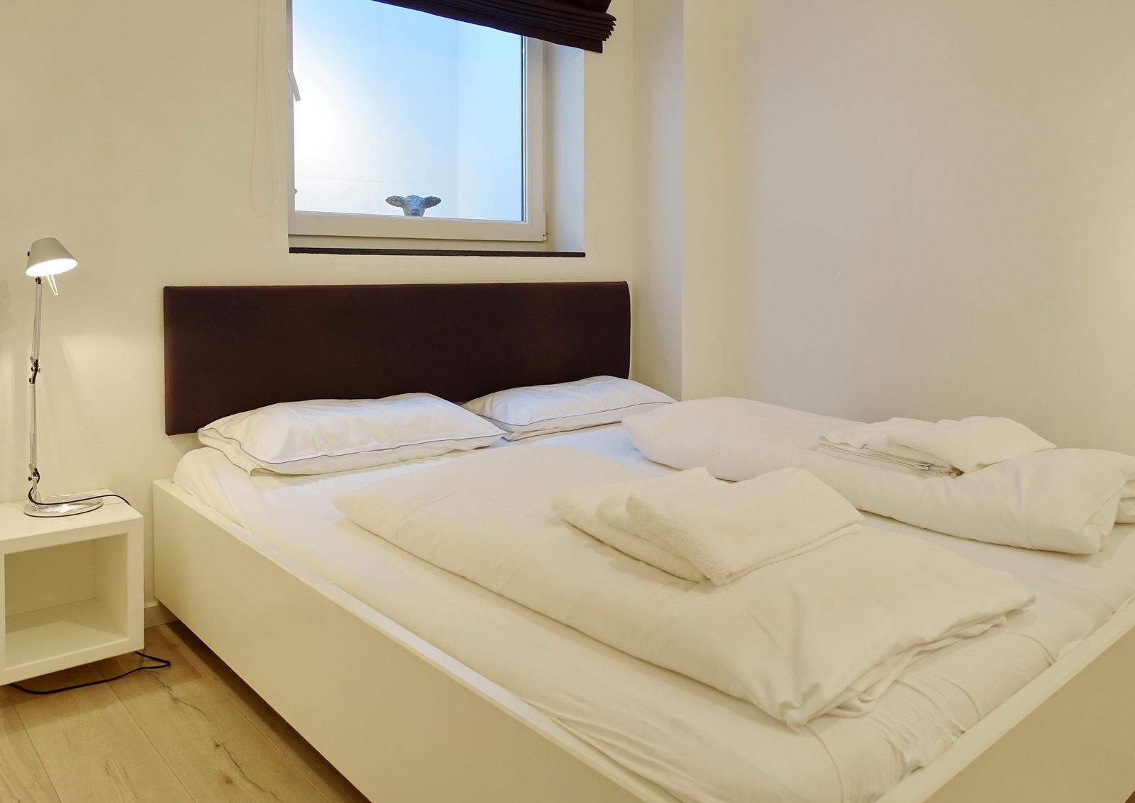 Bedroom with bed, nightstand, and window