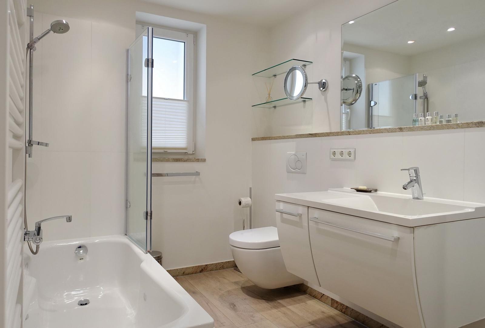 Bath with bathtub, shower, sink, and mirror