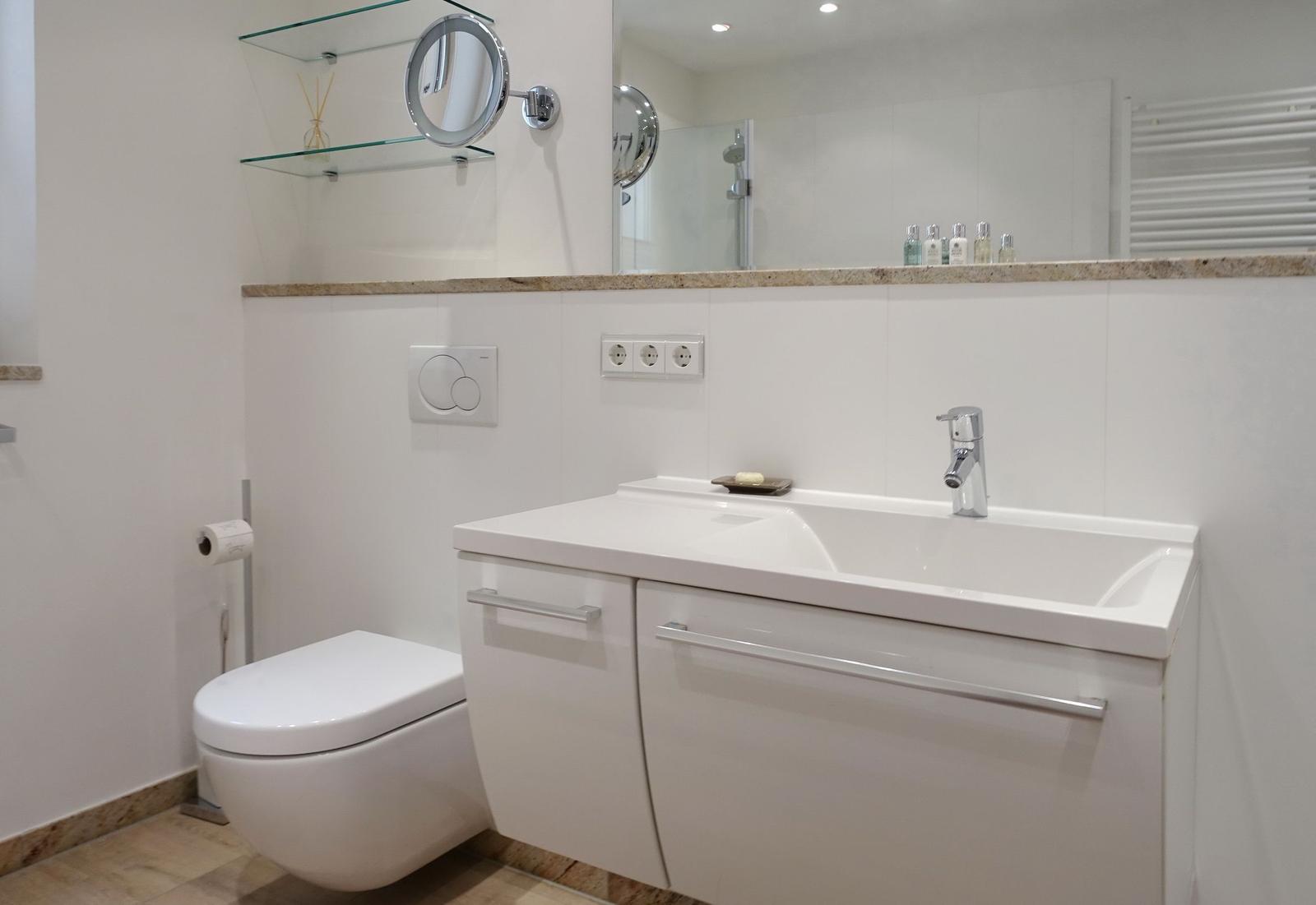 Bathroom with sink, toilet, and mirror
