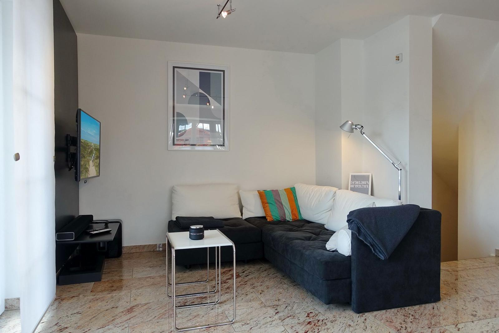 Living room with sofa, TV, and table