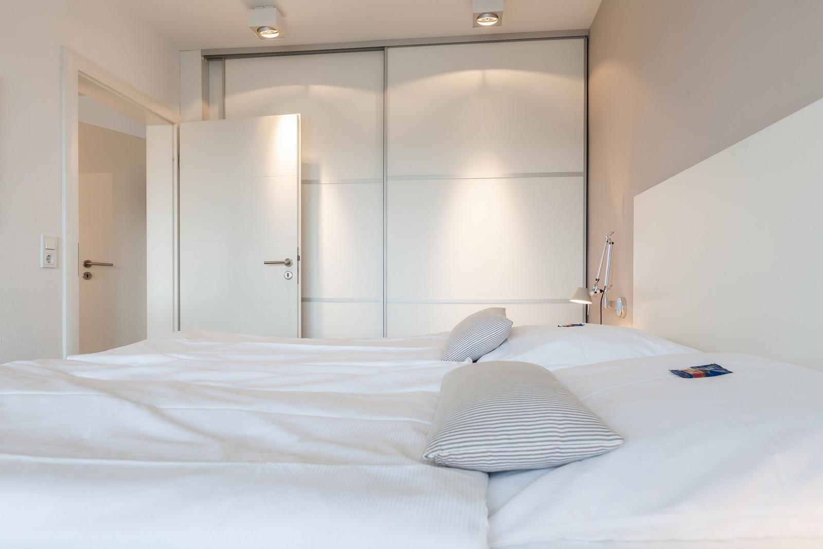 Bedroom with bed, closet, and lamp