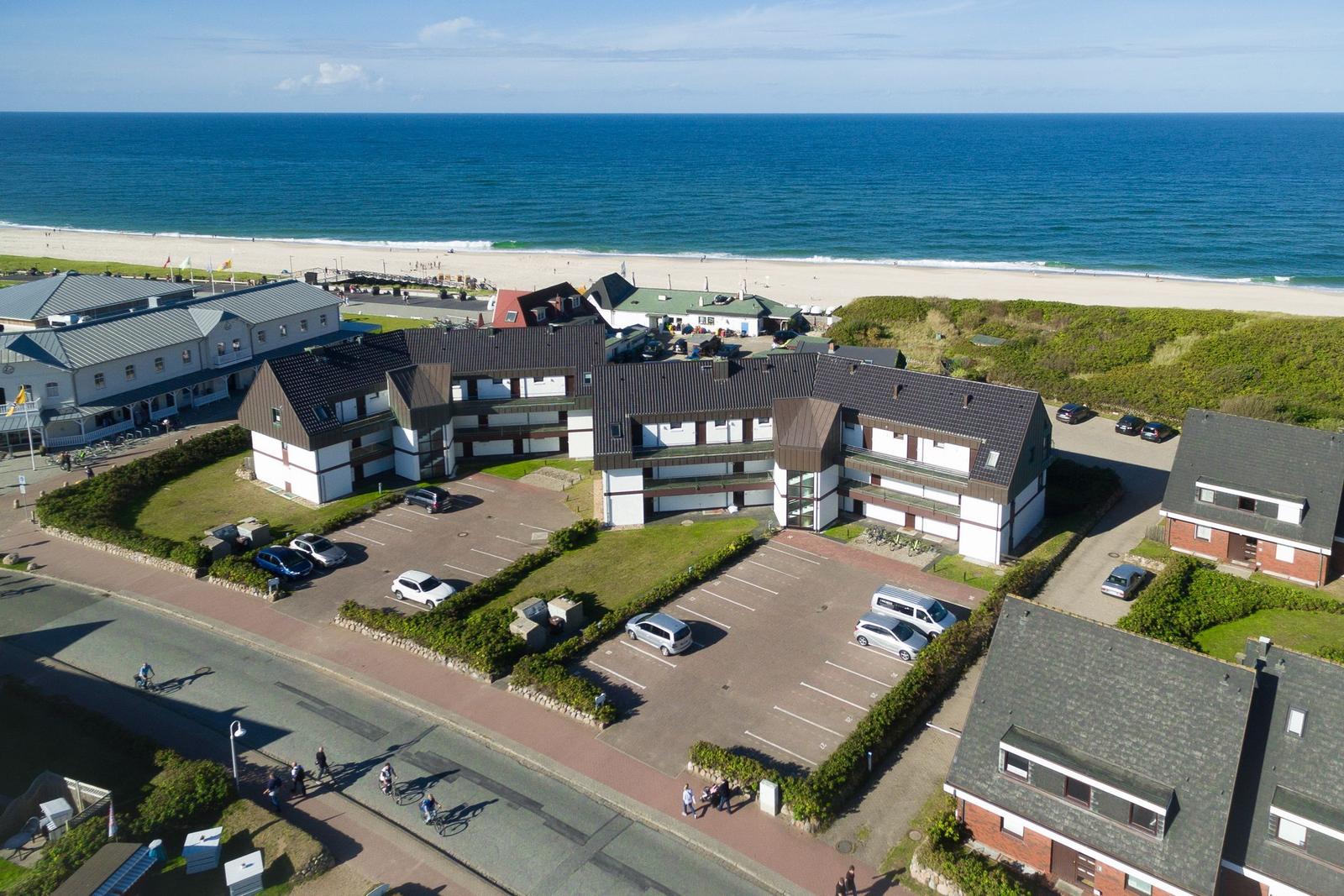 Property with beachfront, parking, and green areas