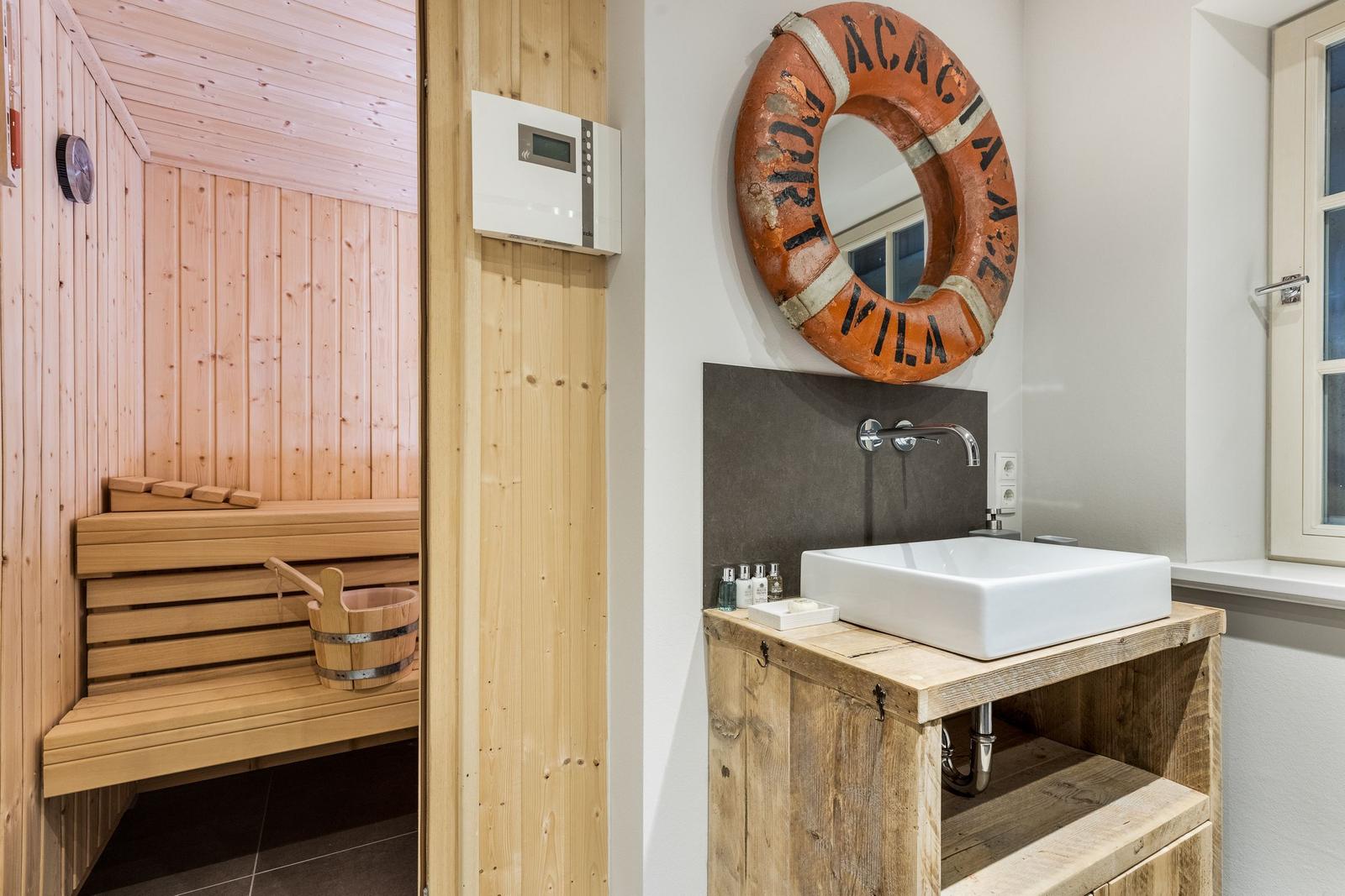 Bathroom with sink and sauna in the background