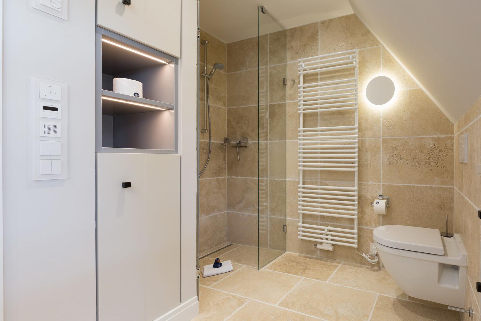 Bathroom with shower, toilet, and heater