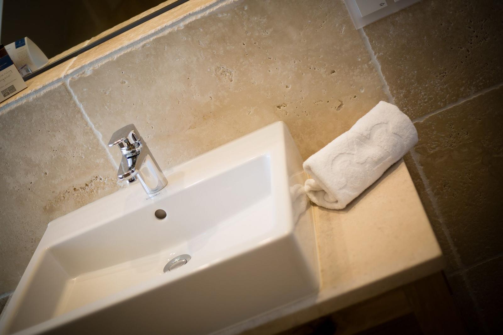 Sink with towel on stone countertop