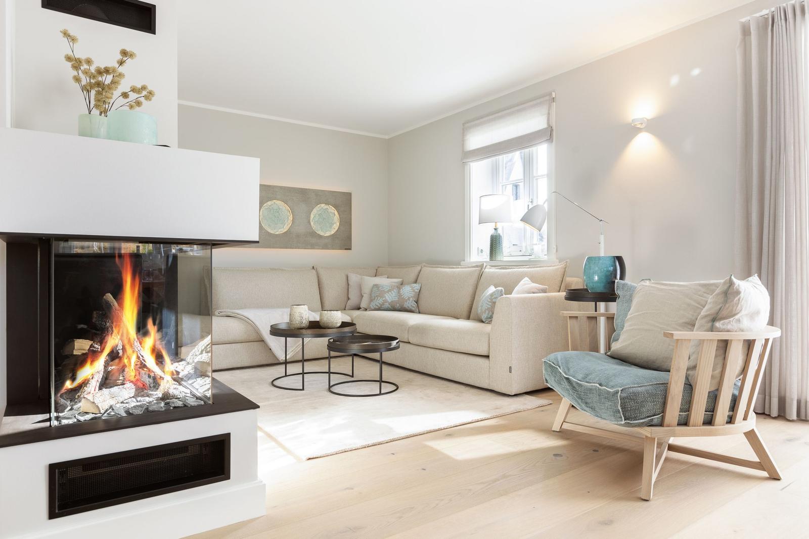 Wohnzimmer mit Kamin, Sofa und Sessel