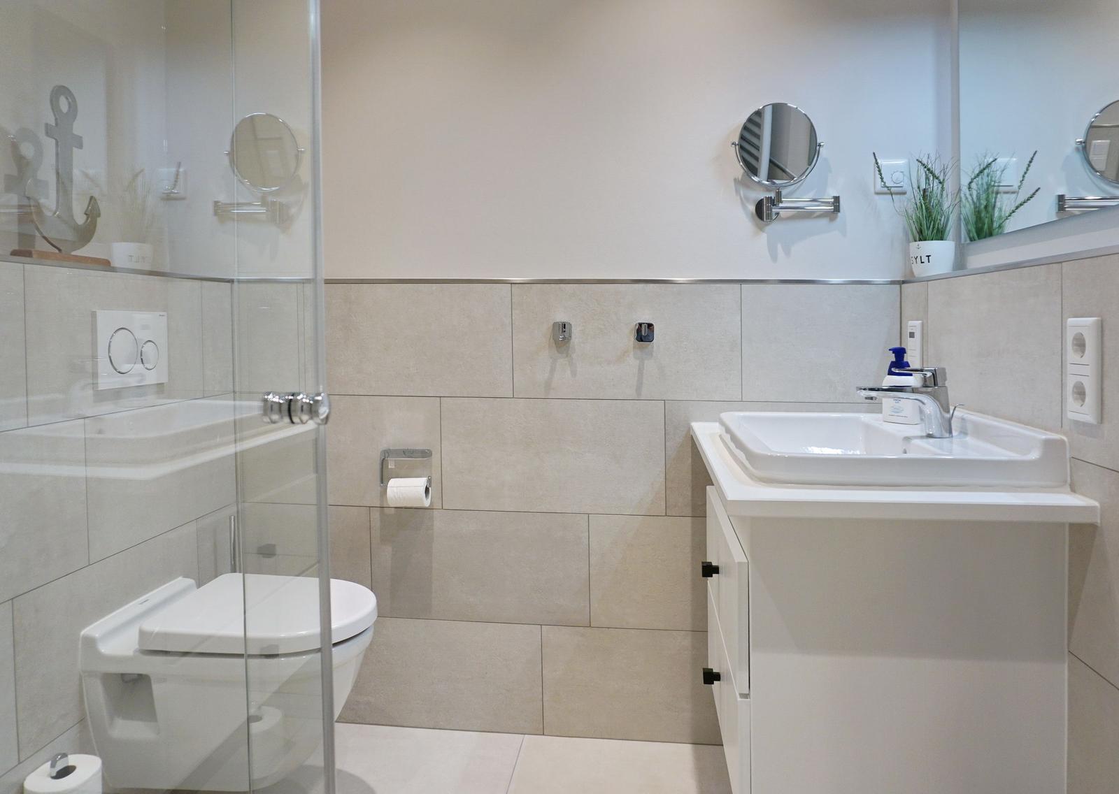 Bathroom with shower, toilet, and sink