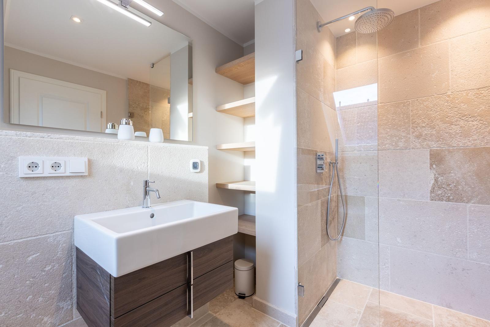 Bathroom with shower, sink, and mirror