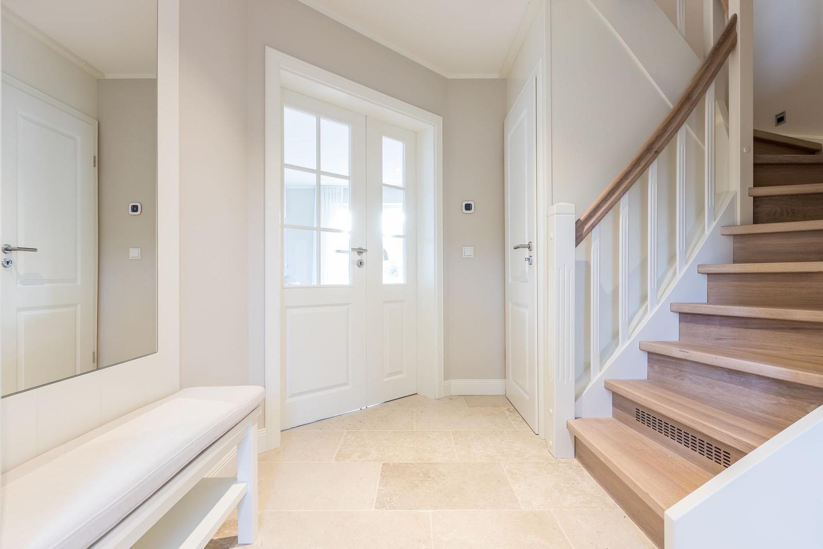 Entrance with stairs, bench, and French doors