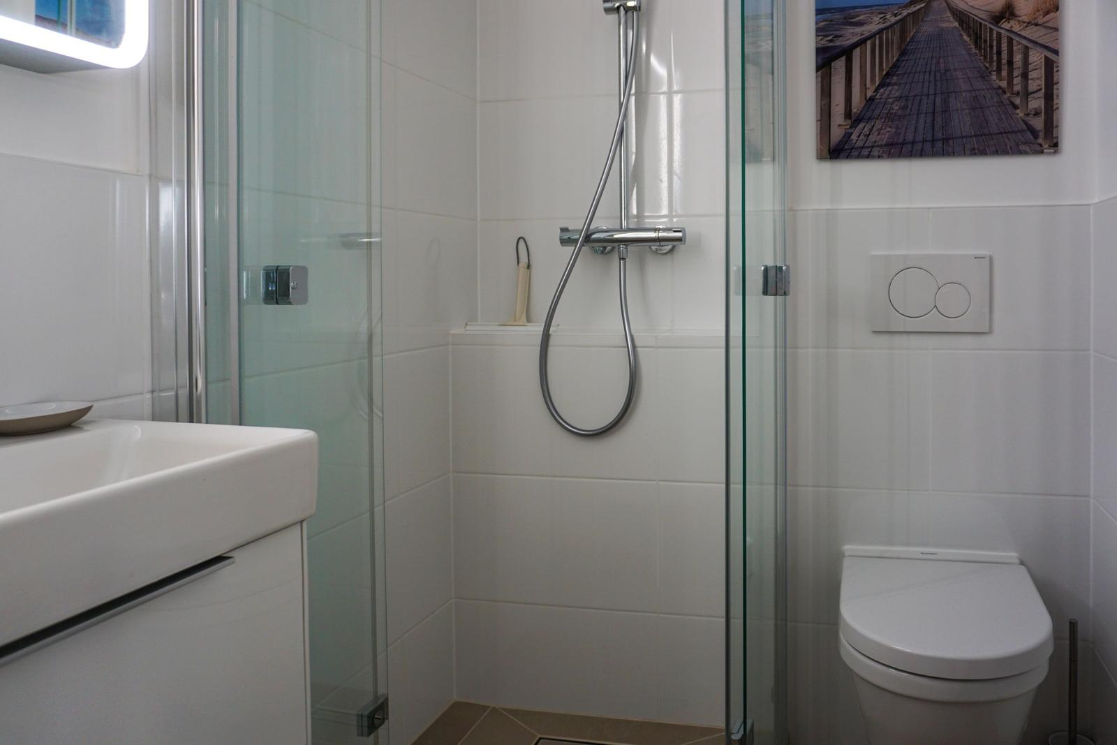 Bathroom with shower, toilet, and sink