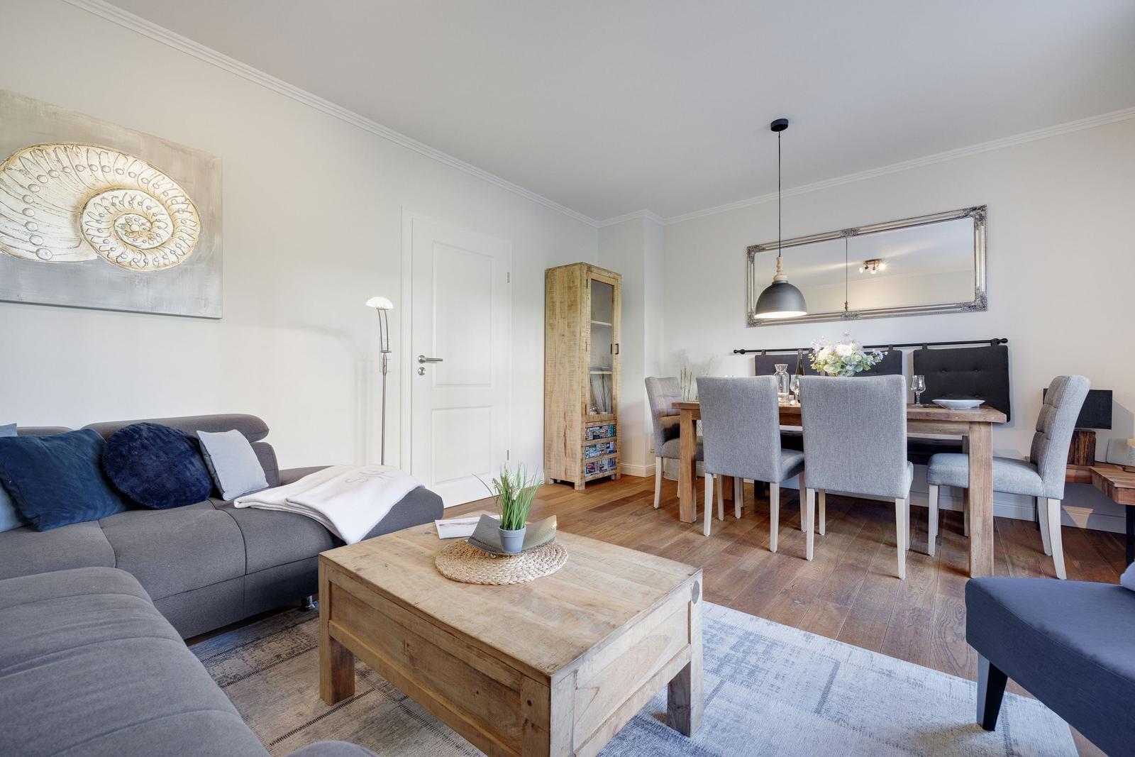 Living and dining area with sofa, table and chairs.