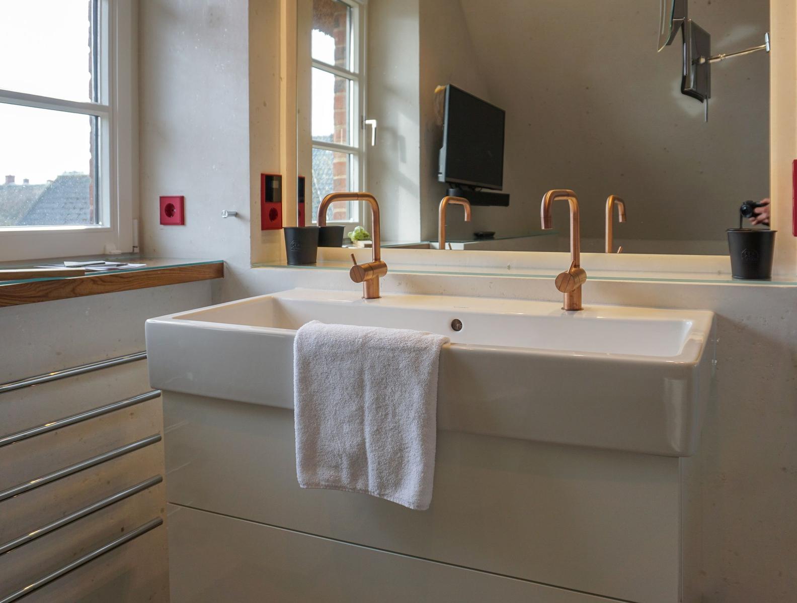 Bathroom with sink, mirror, and window