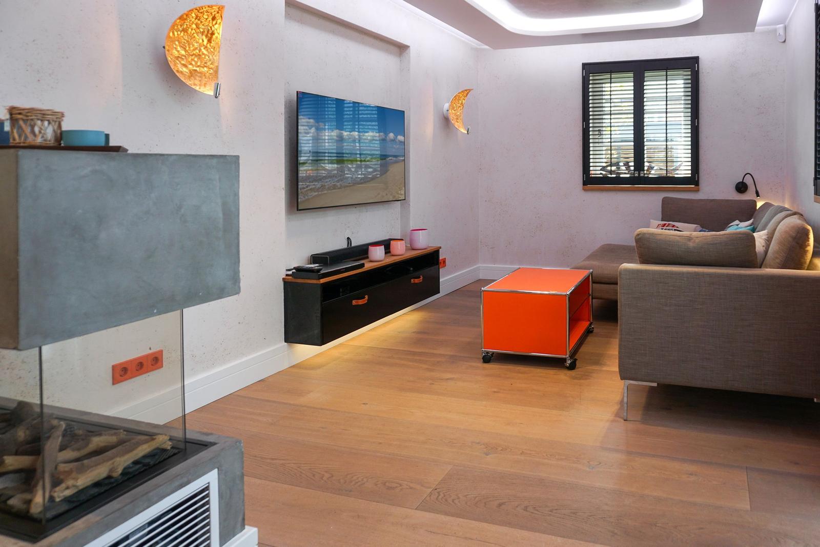 Living room with sofa, TV, and fireplace