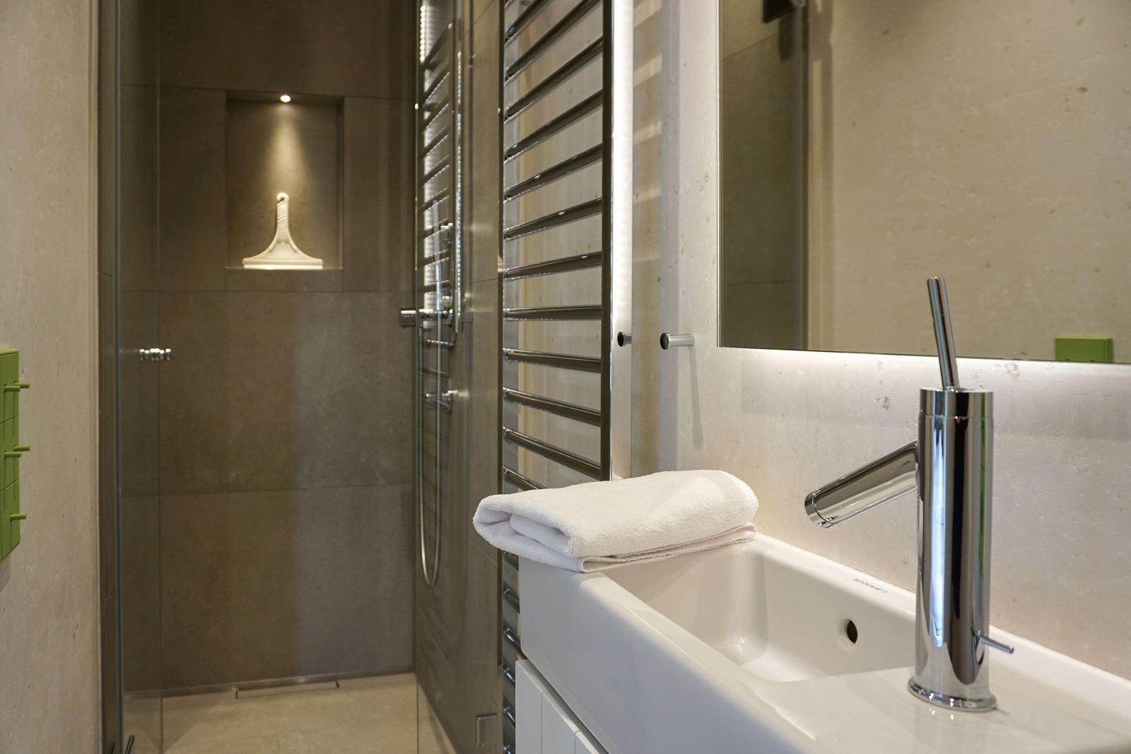 Bathroom with shower, sink, and towel