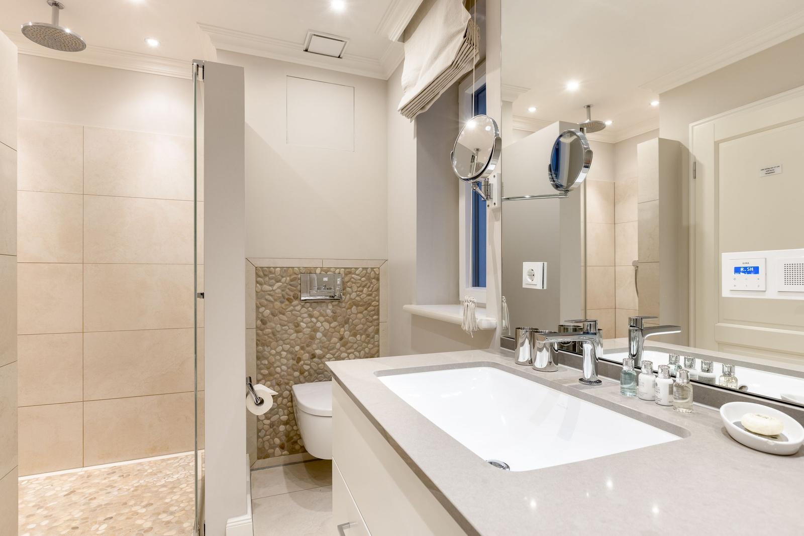 Bathroom with shower, sink, and toilet.
