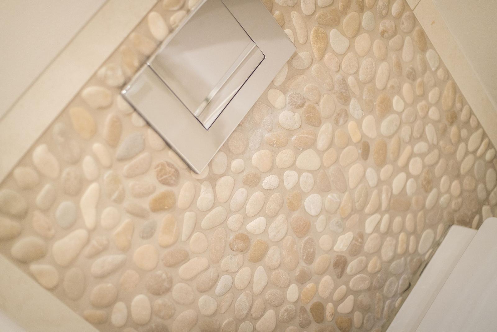 Bathtub with stone tiles and modern faucet