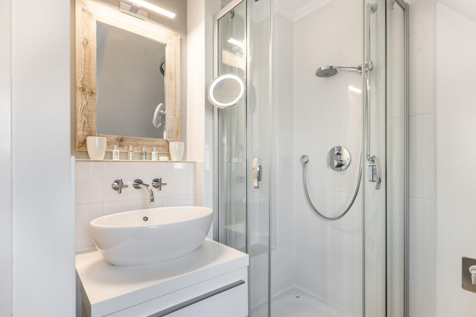 Bathroom with shower, sink, and mirror