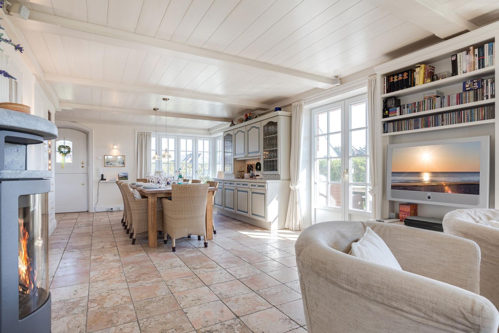 Living and dining area with fireplace, TV, and kitchen