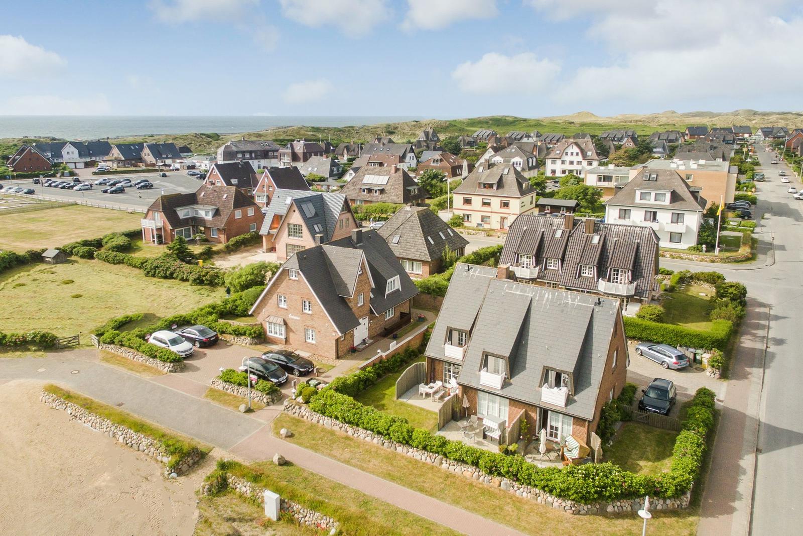 Village with houses and beach in background