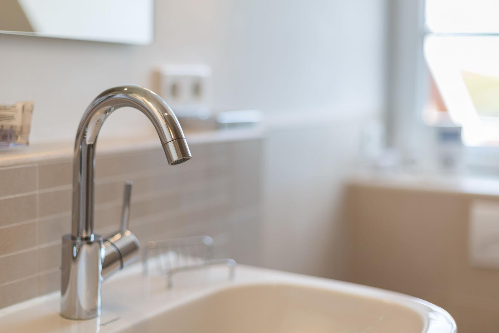 Sink with modern faucet and mirror