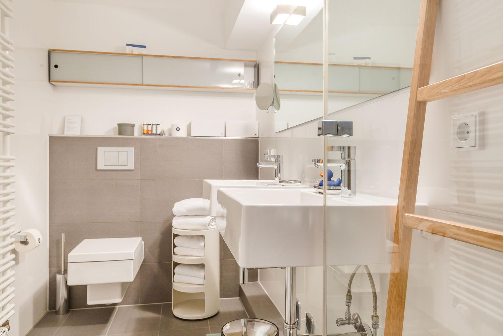 Bathroom with sink, toilet, and shower area.