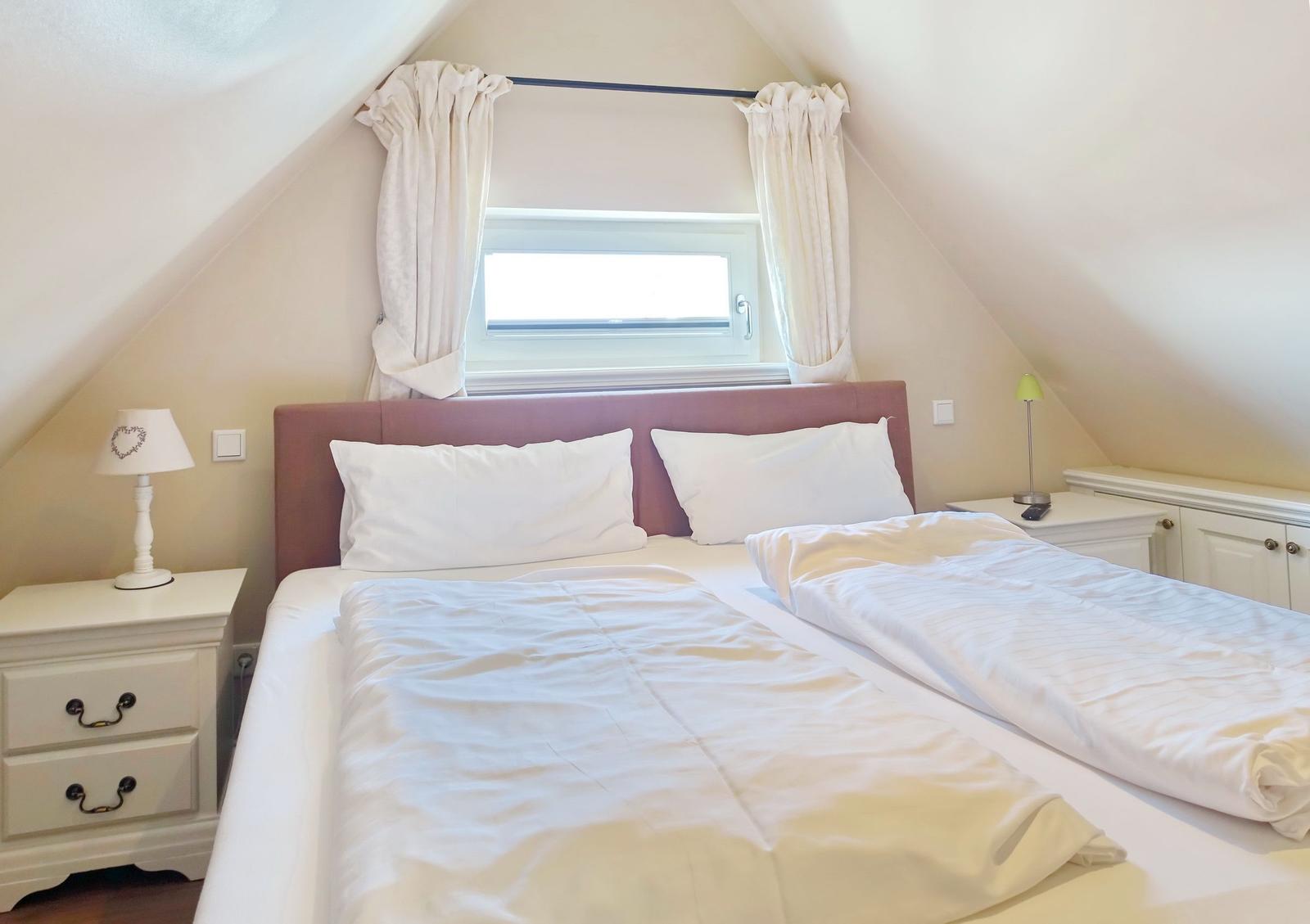 Bedroom with double bed, window, and nightstands