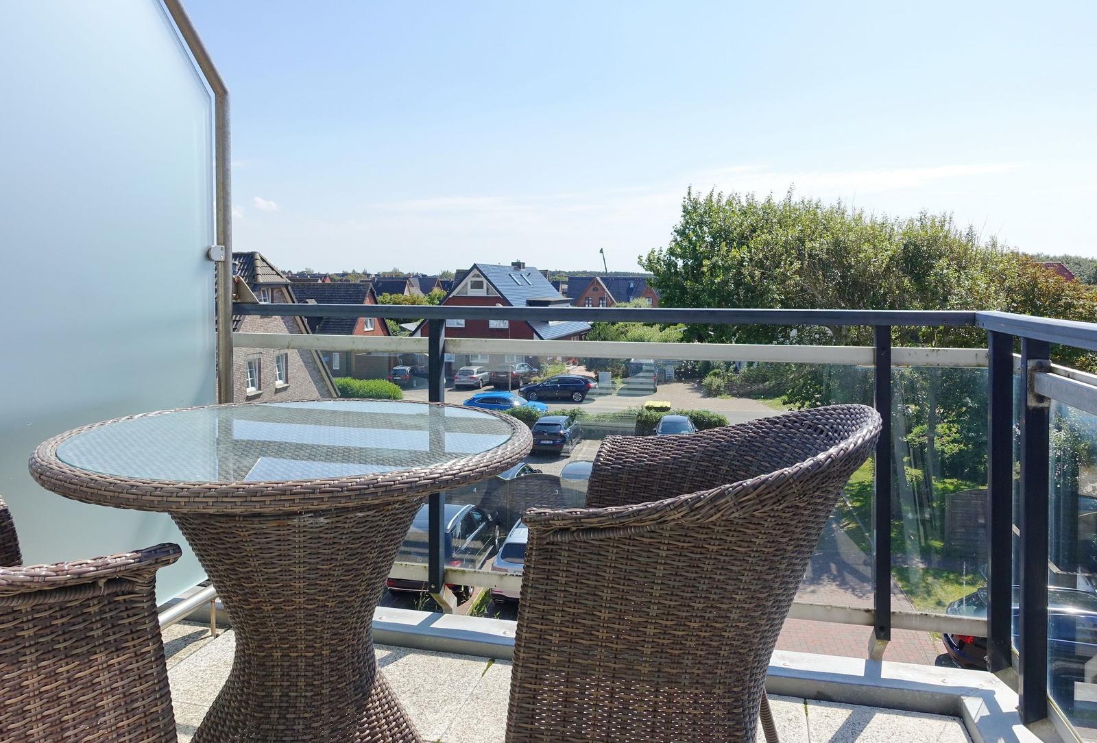 Terrace with wicker furniture and view of residential area