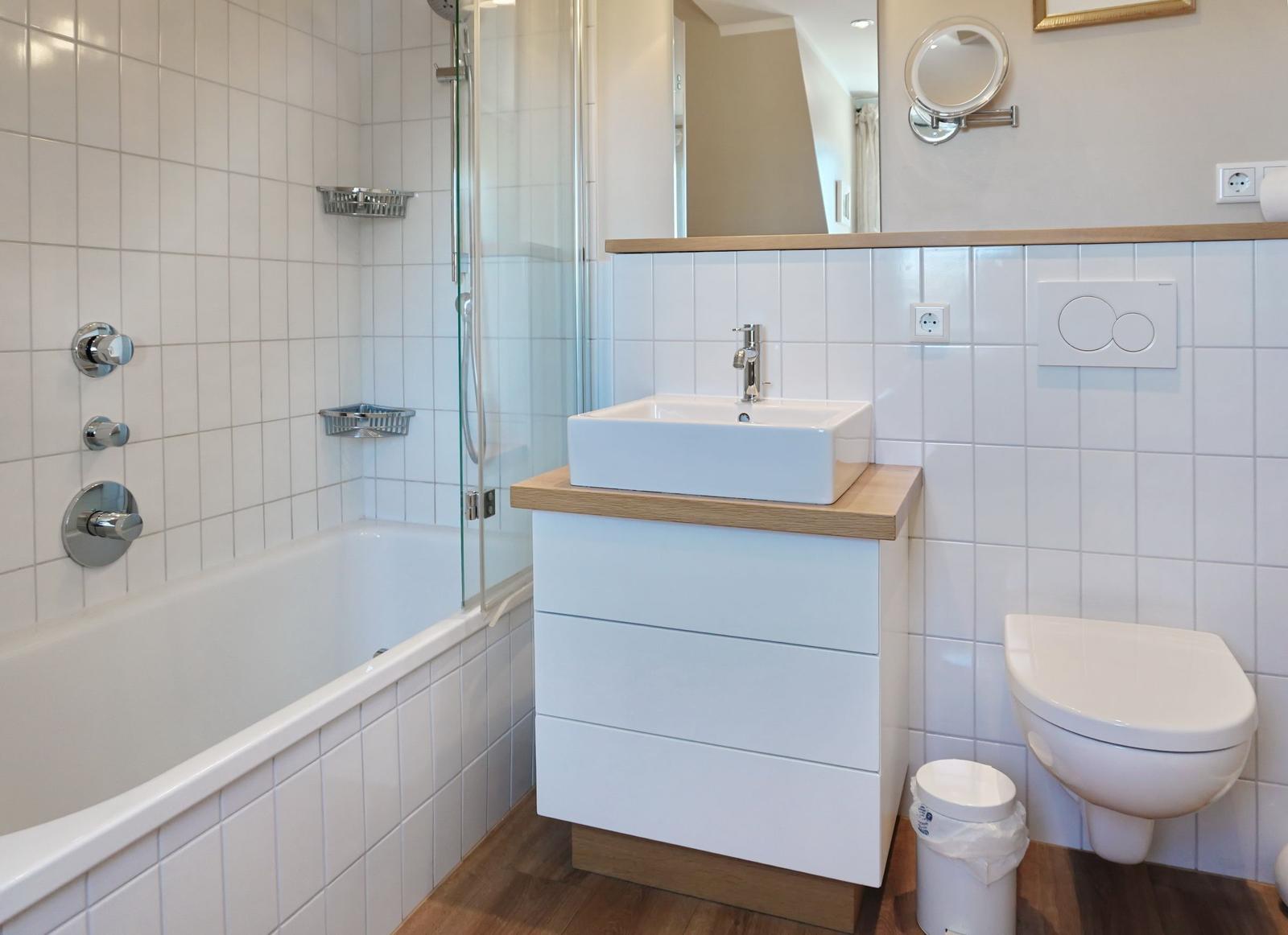 Bathroom with bathtub, shower, sink and toilet.