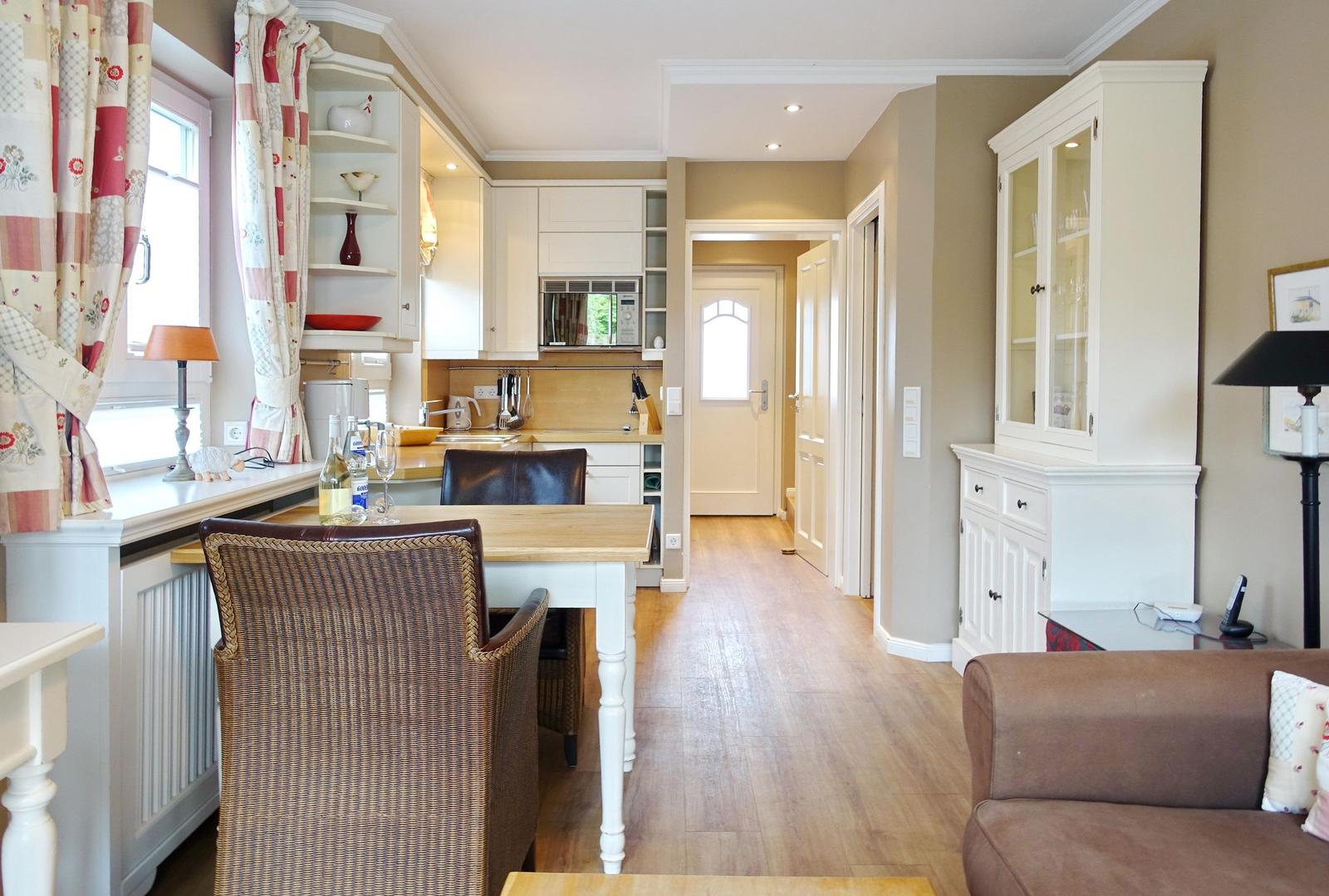 Kitchen with dining table, living area, and hardwood floor