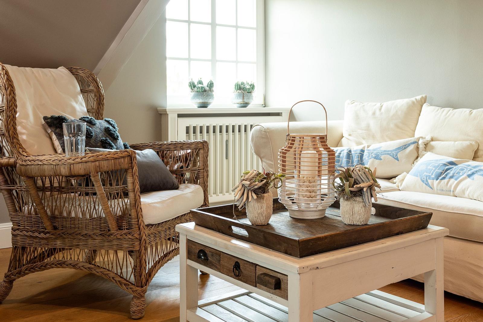 Living room with seating group, sofa and firewood