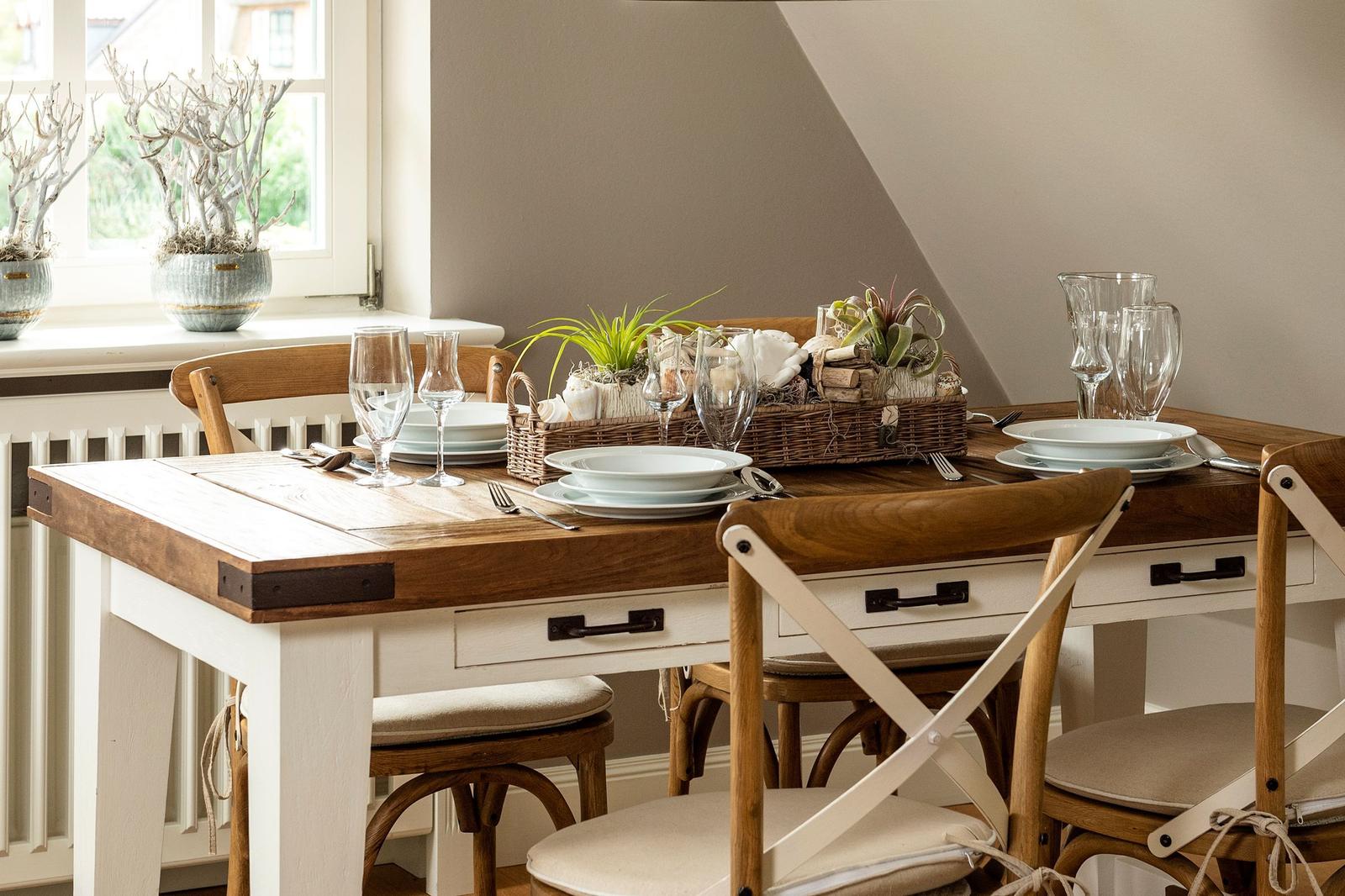 Wooden table with chairs and set table in dining area