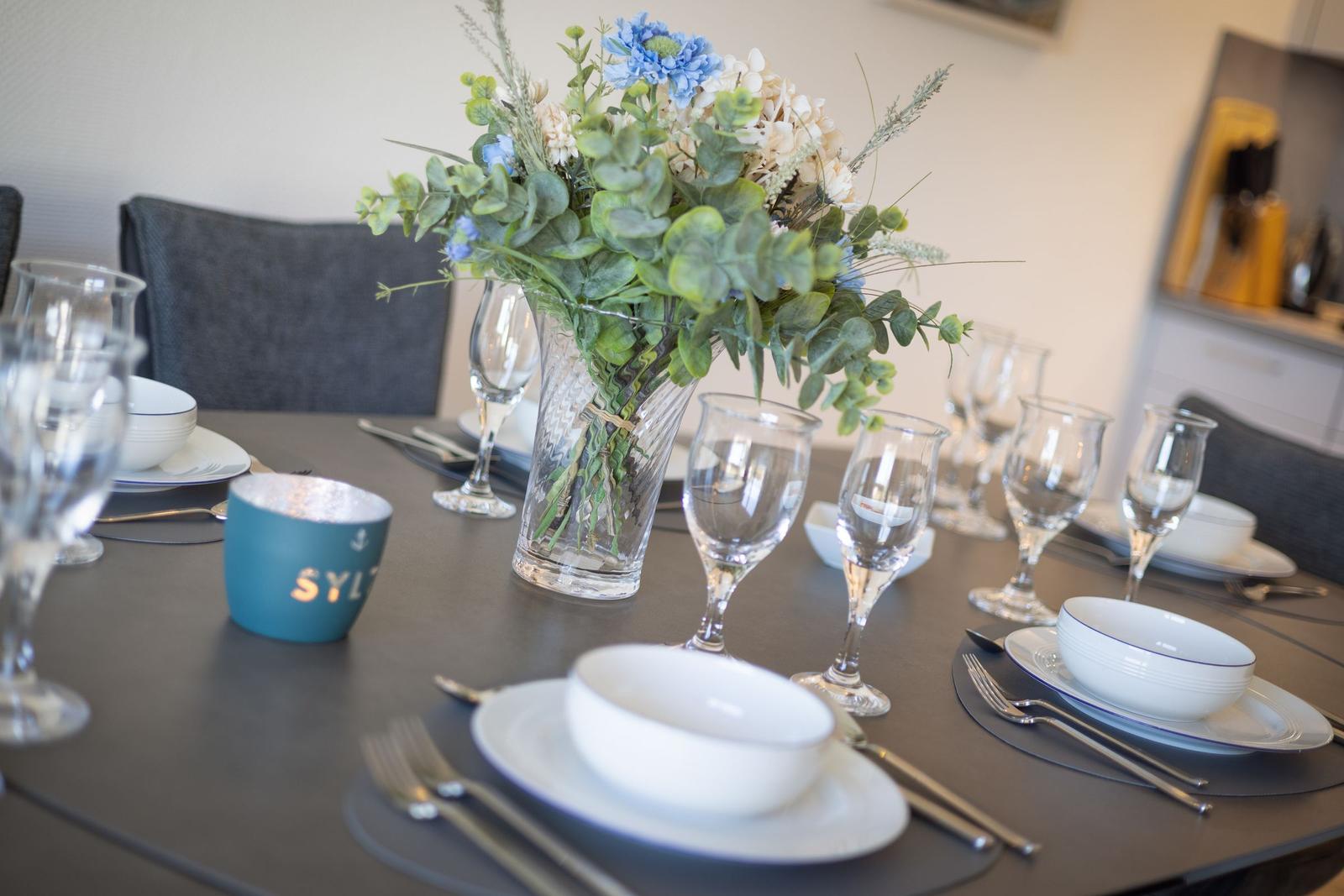 Set dining table with floral arrangement and dishes