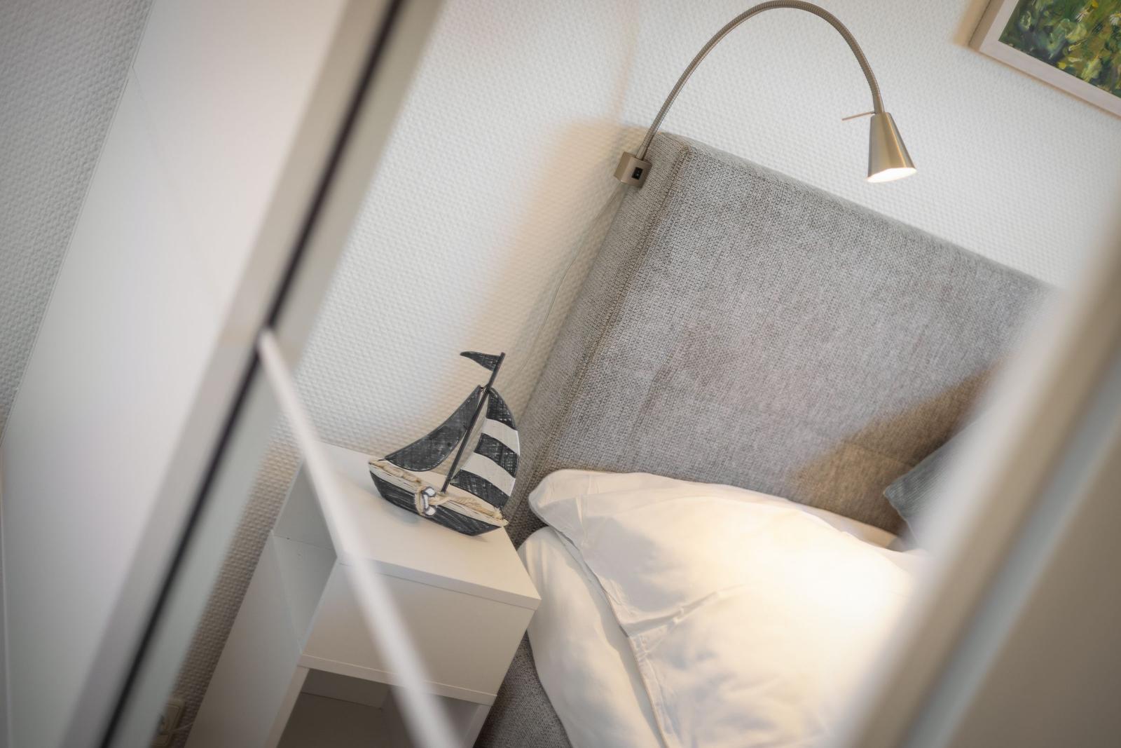 Bed headboard with nightstand and sailboat decoration