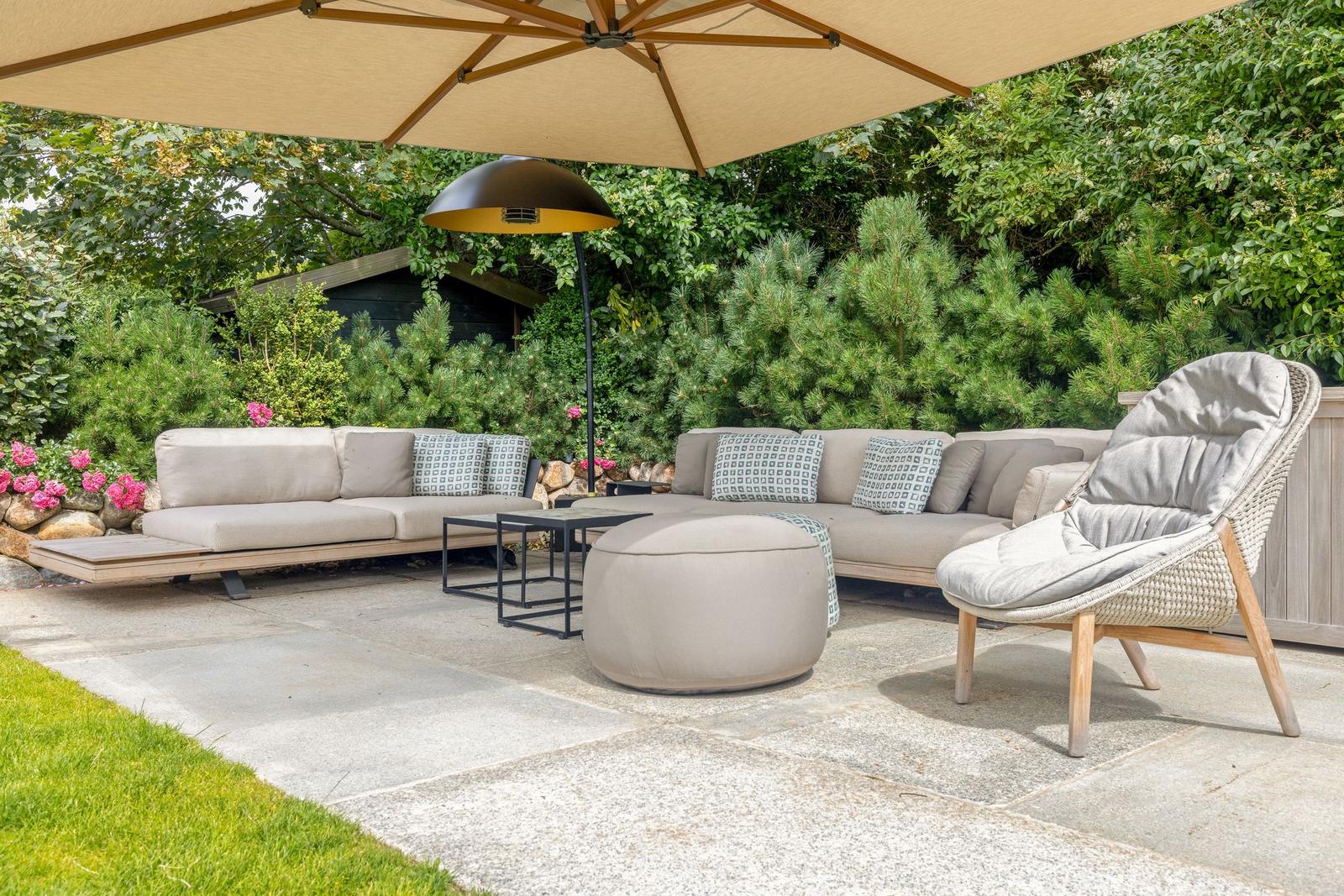 Terrace with seating group, sunshade, and garden lighting.