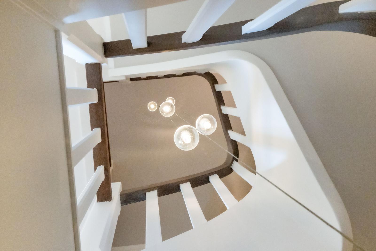 Spiral staircase with modern ceiling lighting