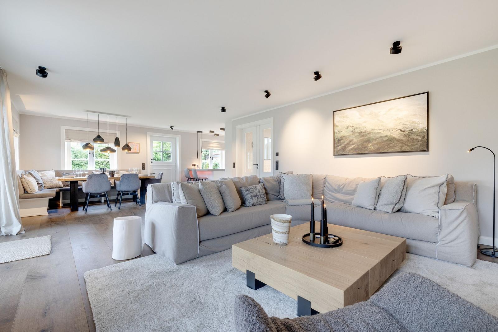 Living room with gray sofa, wooden table, and wall art.