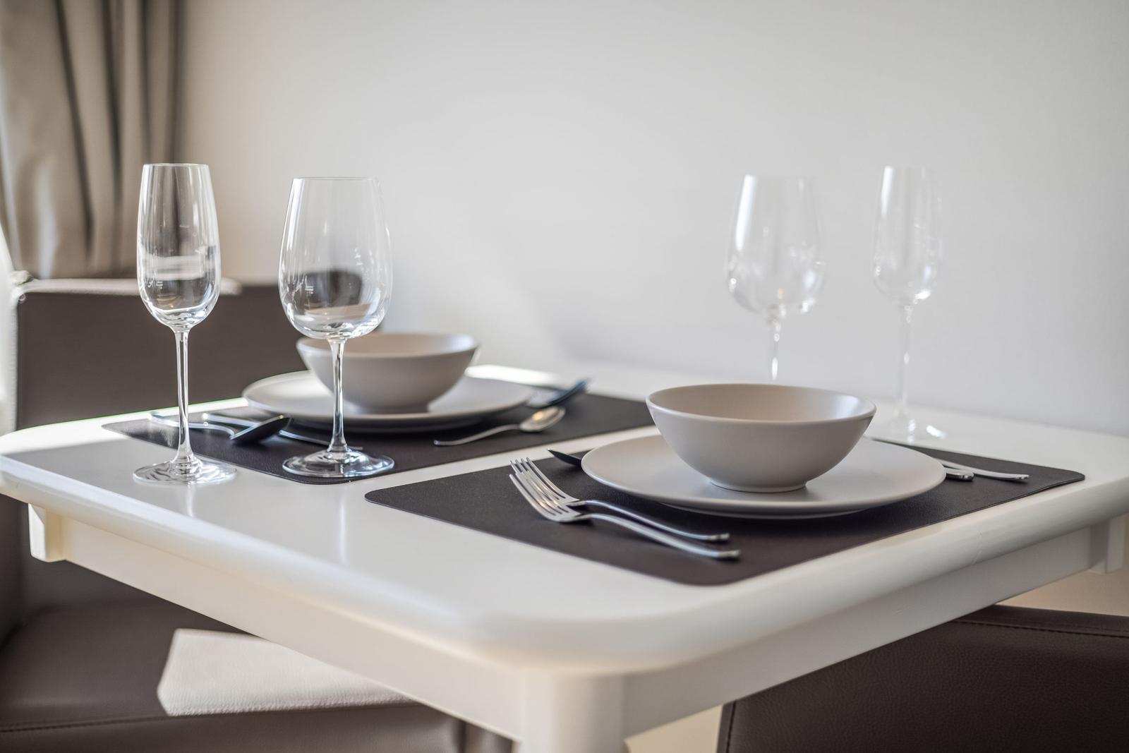 Table set with dishes and glasses for four people