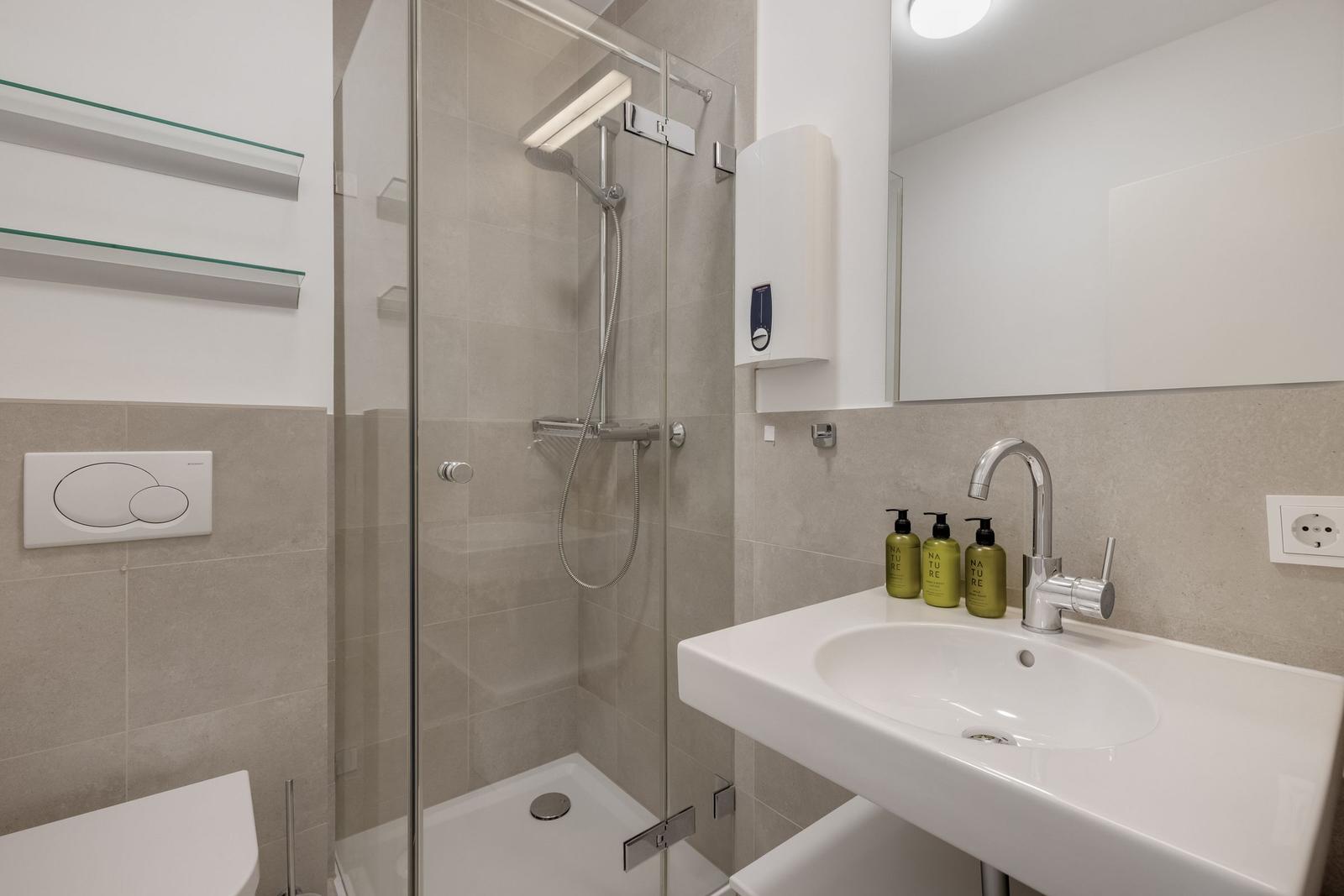 Bathroom with shower, sink and toilet.