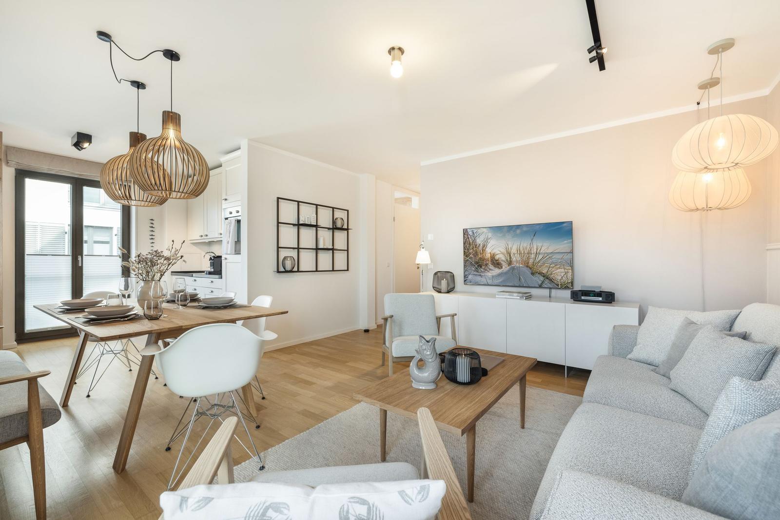 Living and dining area with sofa, dining table, and TV.