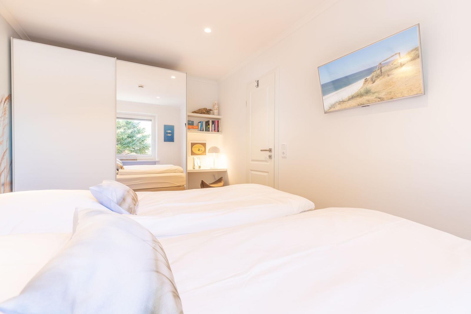 Bedroom with double bed, closet, and wall picture.
