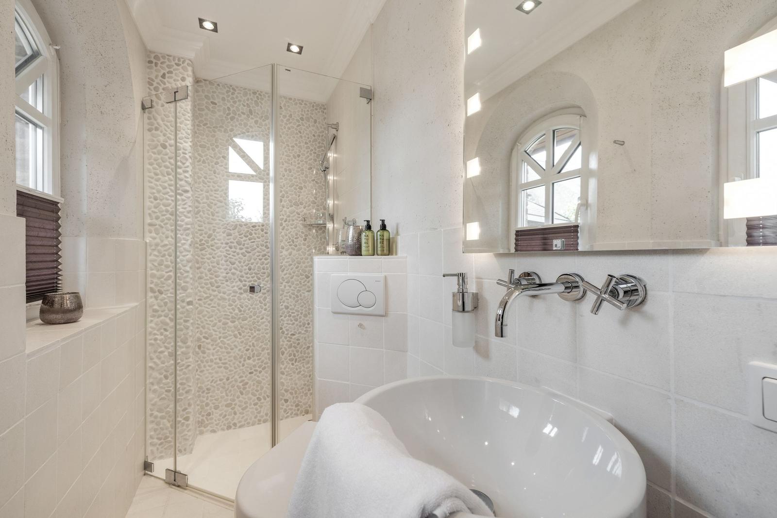 Bathroom with shower, bathtub, and mirror