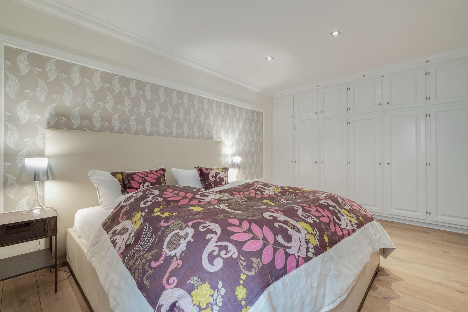 Bedroom with bed, nightstand, and closet
