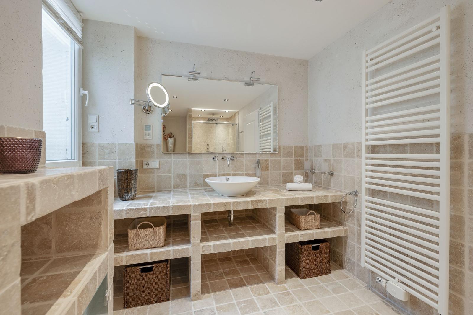 Bathroom with sink, mirror, and radiator