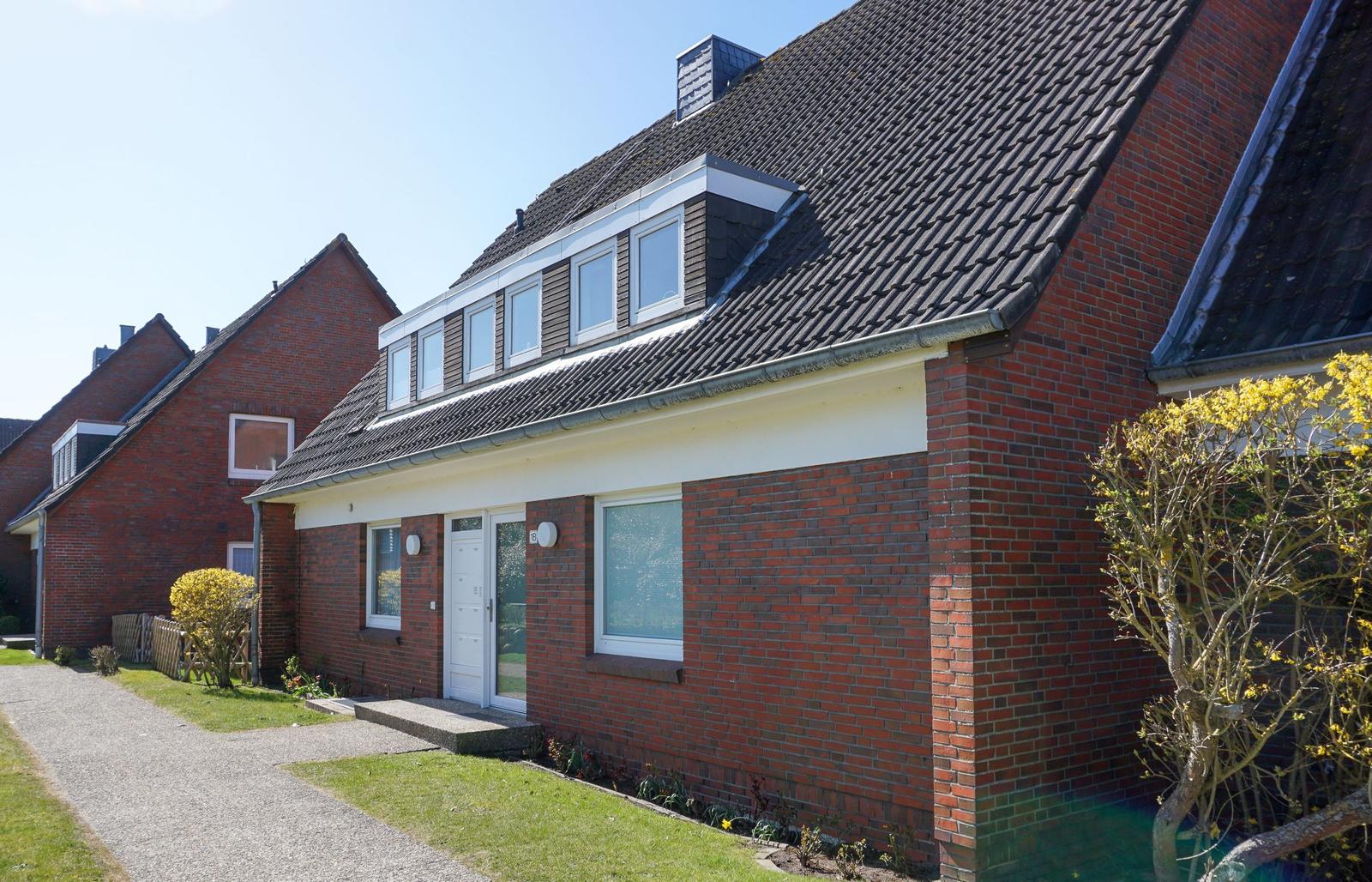 Red brick house with roof windows and front garden