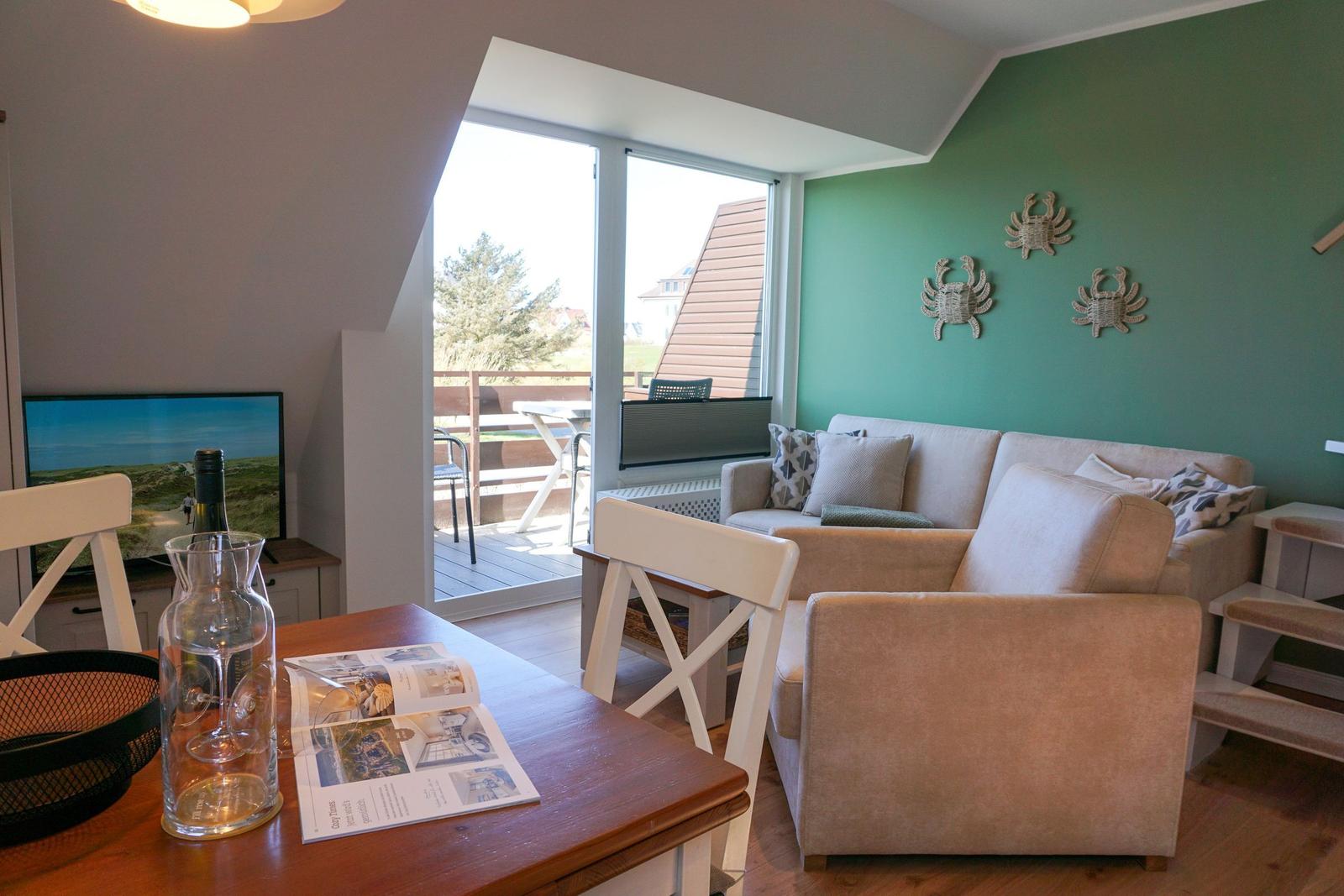 Living room with sofa, table, and balcony view.
